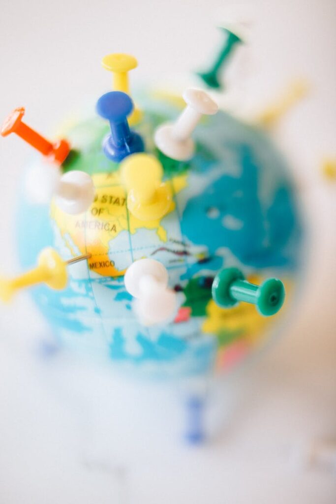 A vibrant globe with colorful pins marking destinations, symbolizing travel plans.